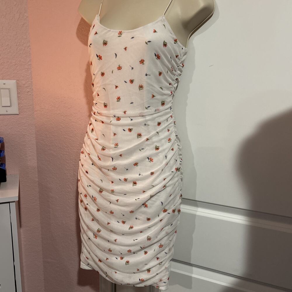 Elegant Spaghetti strap dress with net overlay. Floral pattern & side ruching. ￼